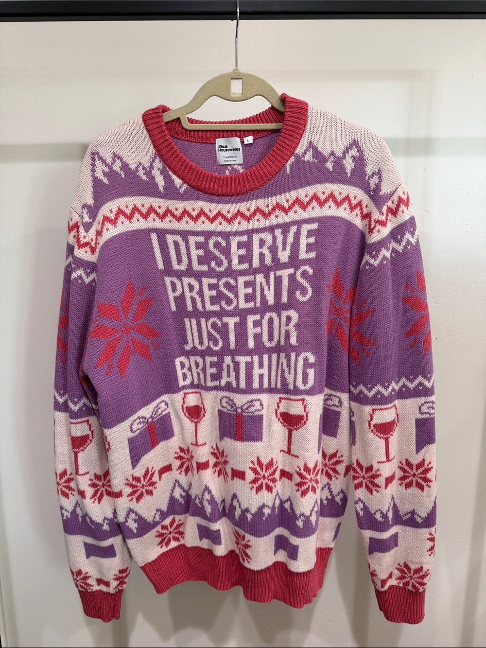 The Real Housewives Purple Holiday Knit Sweater with Pink Trim